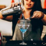 Photo of Woman Pouring Liquid From Drink Mixer