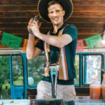 A Happy Bartender in a Sombrero at a Bar