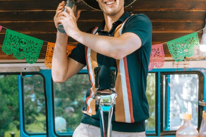 A Happy Bartender in a Sombrero at a Bar