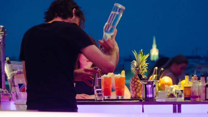 man in black t-shirt preparing tequila at the counter