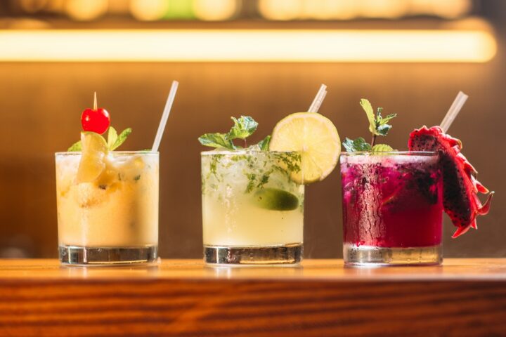 three clear glass cups with juice