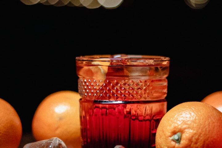 orange fruit beside clear drinking glass