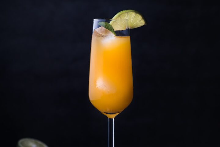 orange juice on clear glass
