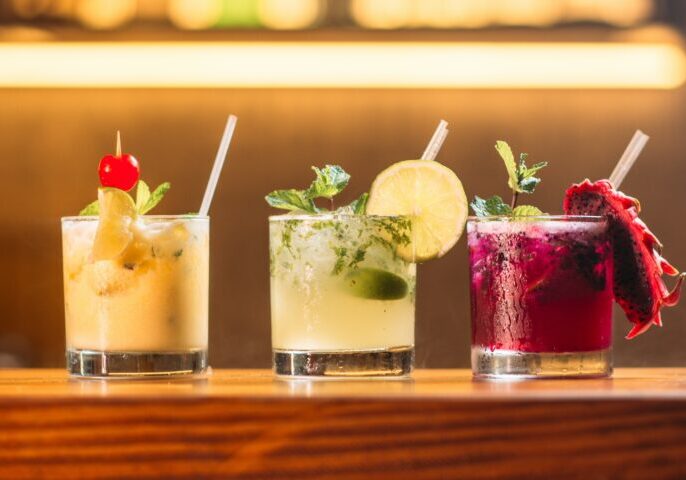 three clear glass cups with juice